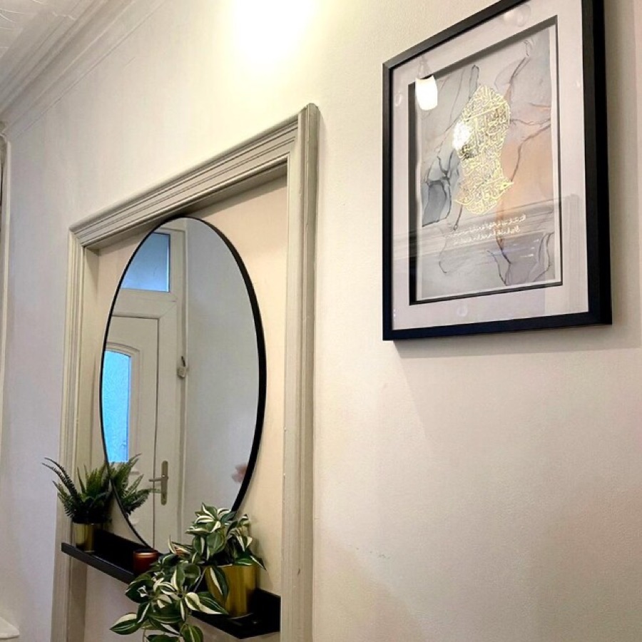 Customer photo: gold-foiled calligraphy print beside a round mirror